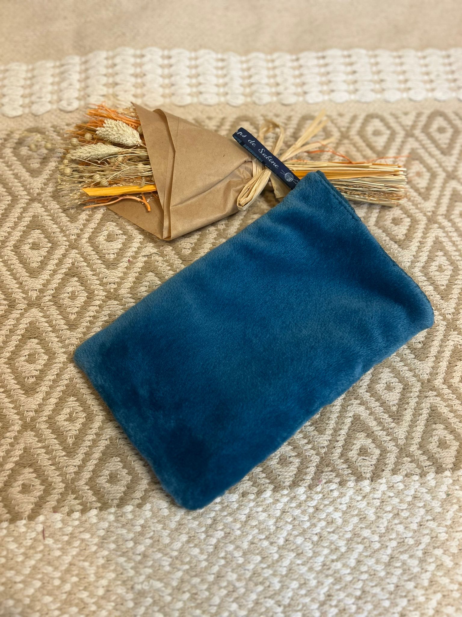 gant de toilette bleu, zero déchet et tapis en fond 
